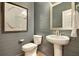 Stylish powder room featuring a pedestal sink, wood paneled walls, contemporary fixtures and decor at 3307 Sawlog Dr, Summerville, SC 29486