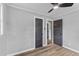 Bedroom featuring wood-look floors, neutral paint, and dark doors to closets and other rooms at 346 Horseshoe Rd, Moncks Corner, SC 29461
