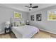 Cozy bedroom with two windows, modern decor, and a ceiling fan at 346 Horseshoe Rd, Moncks Corner, SC 29461