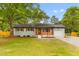 Charming single story home with well-kept lawn, painted brick, and wood and black accents at 346 Horseshoe Rd, Moncks Corner, SC 29461