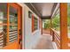 Beautifully designed front porch featuring brick, wooden railings, and a stylish front door with glass panels at 346 Horseshoe Rd, Moncks Corner, SC 29461