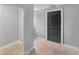 View of a hallway with an entrance and a dark door, flooring is unfinished and gray walls at 346 Horseshoe Rd, Moncks Corner, SC 29461
