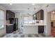 Bright kitchen with white countertops, tile floors, stainless appliances, and dark cabinetry at 35 Society # H, Charleston, SC 29401