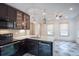 Bright kitchen with white countertops, tile floors, stainless appliances, and dark cabinetry at 35 Society # H, Charleston, SC 29401