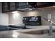 Close up on modern kitchen featuring stainless steel appliances, a decorative backsplash, and sleek countertops at 35 Society # H, Charleston, SC 29401