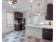 Bright kitchen with white countertops, tile floors, stainless appliances, and dark cabinetry at 35 Society # H, Charleston, SC 29401