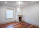 Living room with hardwood floors, a fireplace, and natural light streaming through a window at 35 Society # H, Charleston, SC 29401
