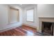 Living room with hardwood floors, a fireplace, and natural light streaming through a window at 35 Society # H, Charleston, SC 29401