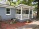 Attractive front porch with white railings and gray brick, enhanced by colorful landscaping and mulch at 354 Deloach Ave, Walterboro, SC 29488