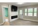 Bright living room with modern fireplace, neutral walls, updated flooring, and ample natural light at 354 Deloach Ave, Walterboro, SC 29488
