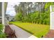 Large backyard featuring lush green grass, mature trees, and a charming playset at 3587 Goodwater St, Mount Pleasant, SC 29466
