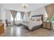 Large bedroom with chandelier, three windows, and white bedding at 3587 Goodwater St, Mount Pleasant, SC 29466