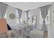 Cozy bedroom with natural light from many windows and a decorative mirror at 3587 Goodwater St, Mount Pleasant, SC 29466