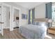 Bright bedroom features ensuite bathroom, wood floors, and blue accents at 3587 Goodwater St, Mount Pleasant, SC 29466