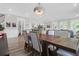 Elegant dining room featuring an eye-catching chandelier and seamlessly flows into the kitchen and living area at 3587 Goodwater St, Mount Pleasant, SC 29466
