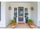 Charming front entrance adorned with potted plants, a wreath, and stylish outdoor lighting at 3587 Goodwater St, Mount Pleasant, SC 29466