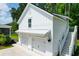 Charming detached two-car garage with white exterior, stairway, and lush green surroundings at 3587 Goodwater St, Mount Pleasant, SC 29466