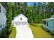 Spacious two-car garage with a private driveway, beautifully landscaped yard, and lush greenery creating a serene backdrop at 3587 Goodwater St, Mount Pleasant, SC 29466