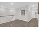 Upstairs hallway with wood floors and a white staircase at 3587 Goodwater St, Mount Pleasant, SC 29466