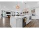 Modern kitchen with a center island, pendant lighting, and a view into the living area at 3587 Goodwater St, Mount Pleasant, SC 29466