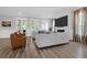 Bright living room with fireplace, large-screen TV, white couches and plenty of natural light at 3587 Goodwater St, Mount Pleasant, SC 29466