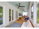 Relaxing covered porch with ceiling fans and outdoor seating and dining area at 3587 Goodwater St, Mount Pleasant, SC 29466