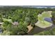 Scenic aerial shot of a home near a golf course and a tranquil pond, surrounded by lush greenery at 3756 Colonel Vanderhorst Circle, Mount Pleasant, SC 29466