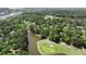 Stunning aerial view showcasing a golf course, a pond, and beautiful homes nestled among mature trees at 3756 Colonel Vanderhorst Circle, Mount Pleasant, SC 29466