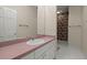 Bathroom featuring a pink countertop, white cabinets, and playful wallpaper at 3756 Colonel Vanderhorst Circle, Mount Pleasant, SC 29466
