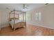 Bright bedroom featuring a four-poster bed, hardwood floors, and sunny windows at 3756 Colonel Vanderhorst Circle, Mount Pleasant, SC 29466