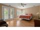 Bright bedroom with hardwood floors, french doors, and shuttered windows at 3756 Colonel Vanderhorst Circle, Mount Pleasant, SC 29466