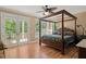 Bedroom with a canopy bed, ceiling fan, and French doors leading to a porch with a view at 3756 Colonel Vanderhorst Circle, Mount Pleasant, SC 29466