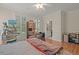 Cozy bedroom has hardwood floors, a ceiling fan, and sunny windows with shutters at 3756 Colonel Vanderhorst Circle, Mount Pleasant, SC 29466