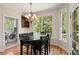 Cozy breakfast nook features a black table set, wood floors, and large windows with natural light at 3756 Colonel Vanderhorst Circle, Mount Pleasant, SC 29466