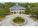 Beautiful white brick clubhouse featuring a circle drive and landscaped roundabout entrance at 3756 Colonel Vanderhorst Circle, Mount Pleasant, SC 29466