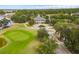 Aerial view of golf course and clubhouse surrounded by trees, gardens, and beautifully landscaped grounds at 3756 Colonel Vanderhorst Circle, Mount Pleasant, SC 29466