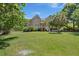 Beautifully landscaped yard surrounds this home with an expansive lawn and mature trees at 3756 Colonel Vanderhorst Circle, Mount Pleasant, SC 29466