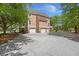 Exterior view of a multi-story home with a three car garage and large driveway at 3756 Colonel Vanderhorst Circle, Mount Pleasant, SC 29466