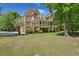 Charming home featuring spacious decks, large windows, and a beautifully landscaped yard with mature trees at 3756 Colonel Vanderhorst Circle, Mount Pleasant, SC 29466