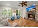 Relaxing living room featuring a brick fireplace, hardwood floors, and comfortable seating at 3756 Colonel Vanderhorst Circle, Mount Pleasant, SC 29466