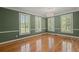 Elegant living room with plantation shutters, hardwood floors, and classic chandelier at 3756 Colonel Vanderhorst Circle, Mount Pleasant, SC 29466