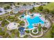 Aerial view of a large community pool featuring a water slide, ample seating, and mature landscaping at 3756 Colonel Vanderhorst Circle, Mount Pleasant, SC 29466