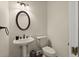 Classic powder room with pedestal sink, oval mirror, and neutral wall color at 3756 Colonel Vanderhorst Circle, Mount Pleasant, SC 29466