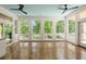 Bright sunroom with floor to ceiling windows, wood floors, and blue wood paneled ceiling at 3756 Colonel Vanderhorst Circle, Mount Pleasant, SC 29466