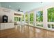 Bright sunroom with floor to ceiling windows, wood floors, wet bar and blue wood paneled ceiling at 3756 Colonel Vanderhorst Circle, Mount Pleasant, SC 29466