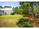 Expansive backyard featuring a well-maintained lawn and mature trees, perfect for outdoor activities and enjoying nature at 380 Tidal Reef Cir, Mount Pleasant, SC 29464