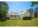 Beautiful home featuring a screened-in porch, lush lawn, and mature trees at 380 Tidal Reef Cir, Mount Pleasant, SC 29464