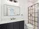 Modern bathroom featuring sleek vanity, minimalist mirror, and a glass-enclosed shower at 380 Tidal Reef Cir, Mount Pleasant, SC 29464