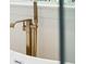 Close up of a modern, high-end gold tub filler fixture in a luxury bathroom at 380 Tidal Reef Cir, Mount Pleasant, SC 29464