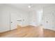 Bright bedroom featuring hardwood floors, white walls, and access to a hallway with a staircase at 380 Tidal Reef Cir, Mount Pleasant, SC 29464
